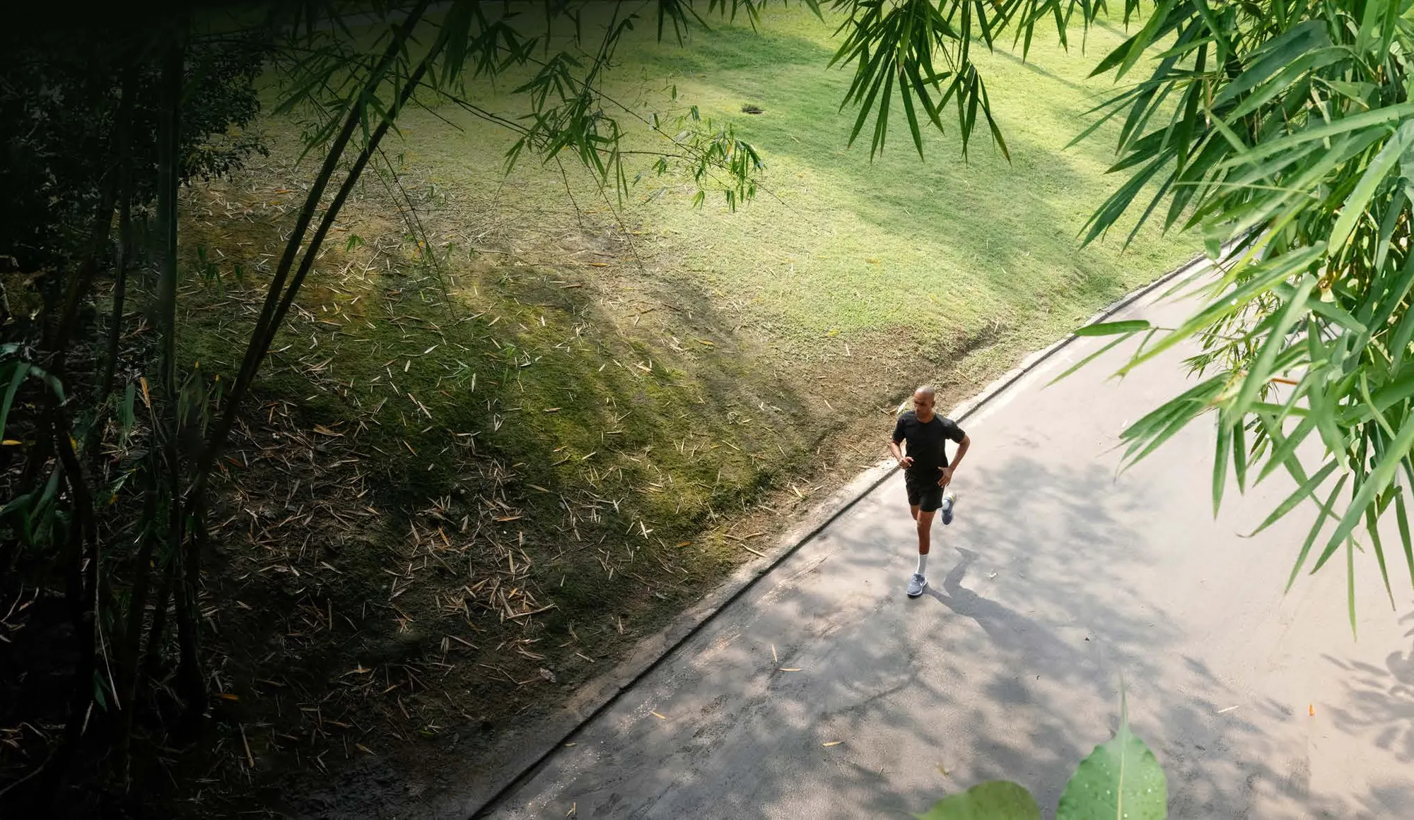 A jogger on a tree-lined walkway, 70% open space at Onyx by Modern Spaaces